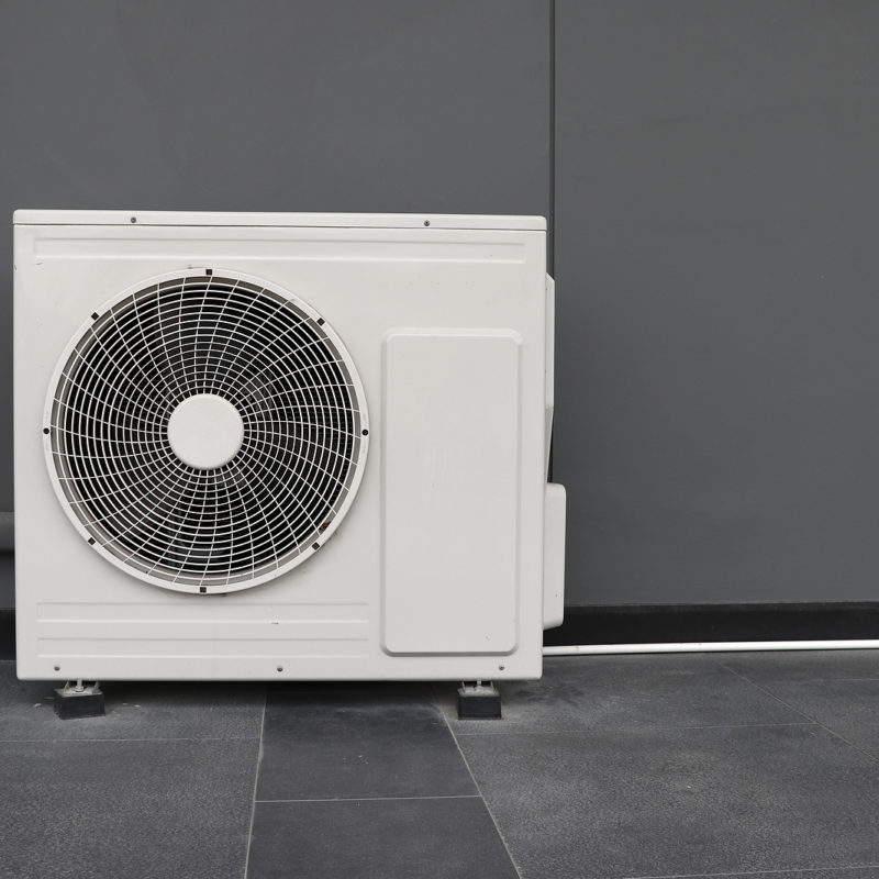 Air-Conditioner-Condensing-Unit-Installed-on-Gray-Wall