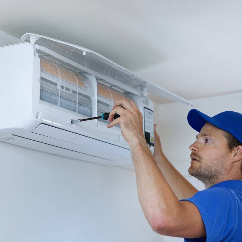 HVAC-Services-Technician-Installing-Air-Conditioner-on-the-Wall-at-Home