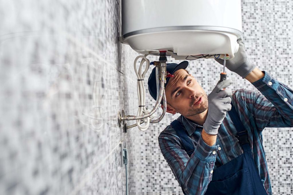 technician repairing boiler